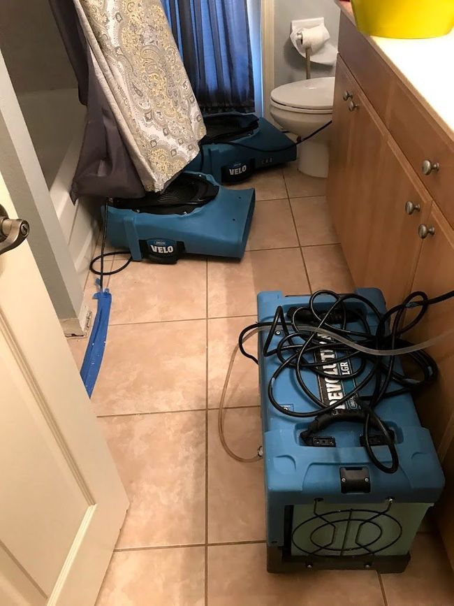 Flood cleanup technician with water extraction unit