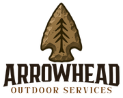 Logo for Arrowhead Outdoor Services featuring a tan stone arrowhead with a black pine tree icon and brown text below.