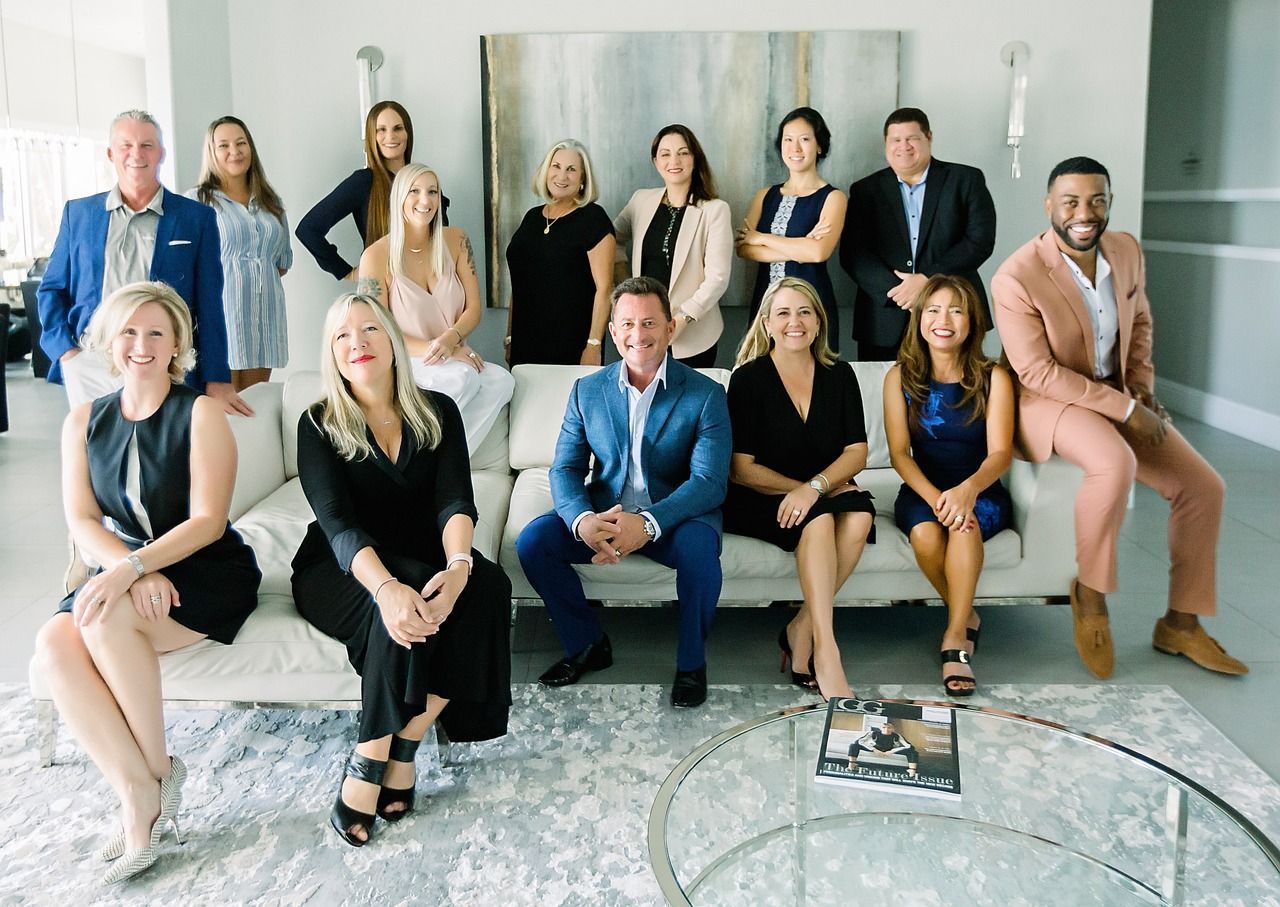 Group of people posing for a photo in a modern living room.