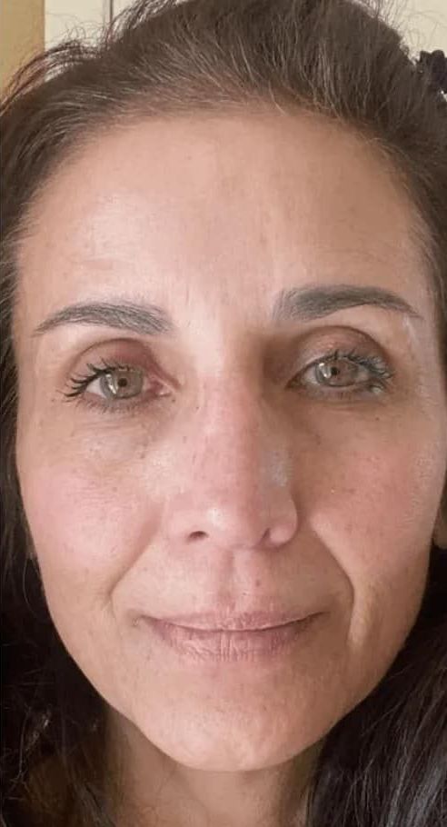 A close up of a woman 's face without makeup.