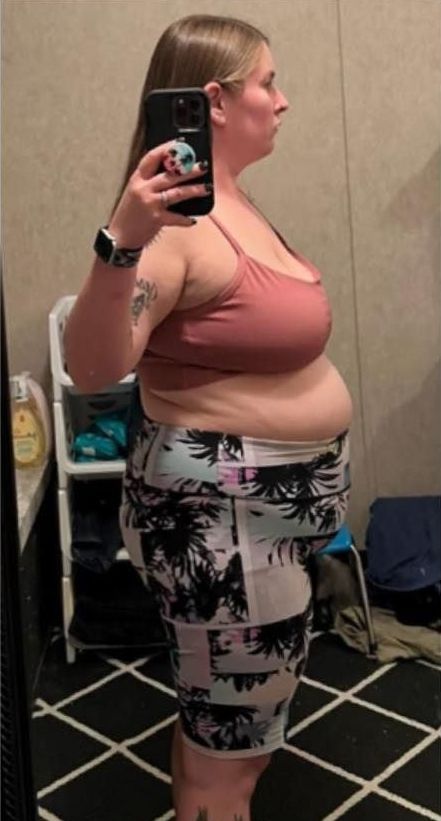 A woman is taking a selfie in front of a mirror.