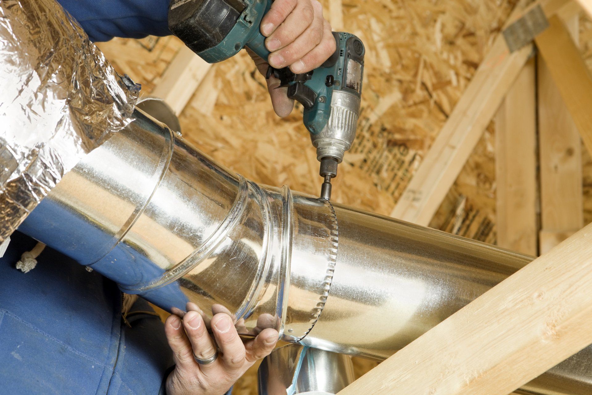 Worker Installing An Attic Vent Duct - Melbourne - Airfixing Heating & Cooling