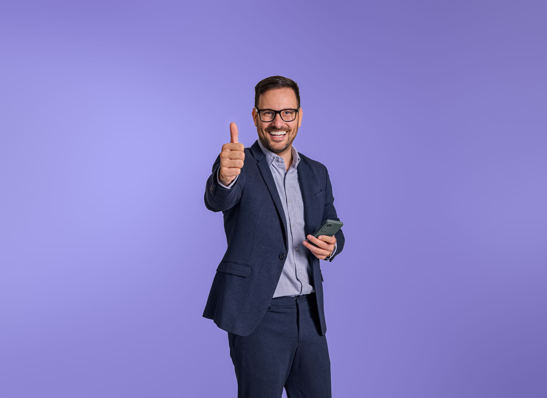 a man in a blue suit with his thumbs up