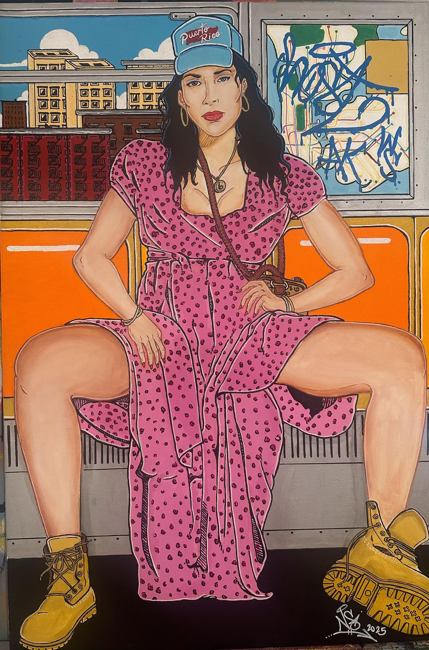 A person wearing a pink polka-dot dress and work boots sits with legs wide apart inside a subway car with graffiti.