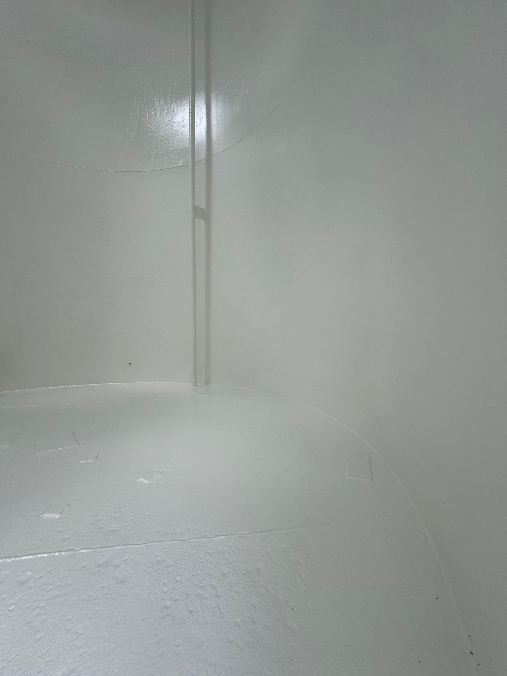 Empty white corner of a room with glossy walls and a light-colored floor