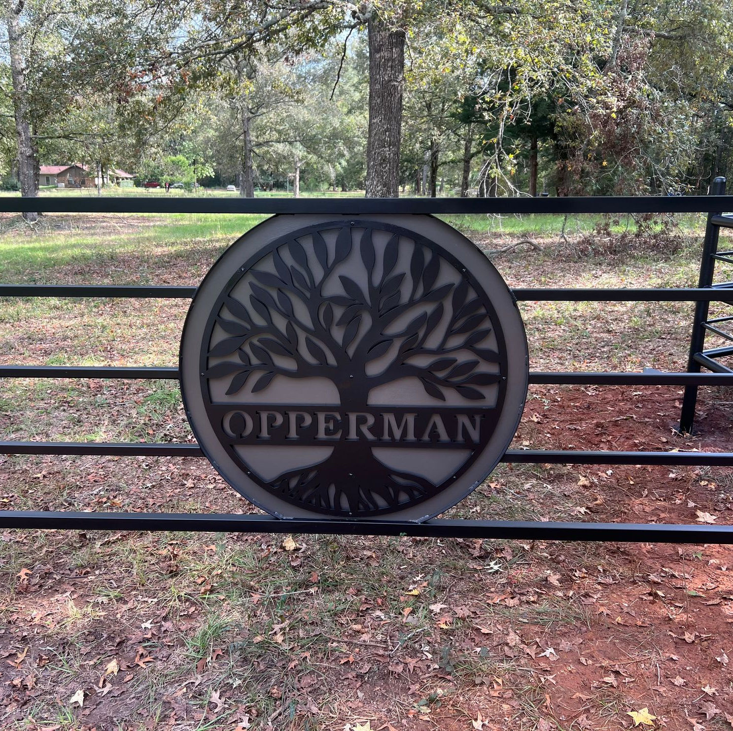 Round black gate sign reading 
