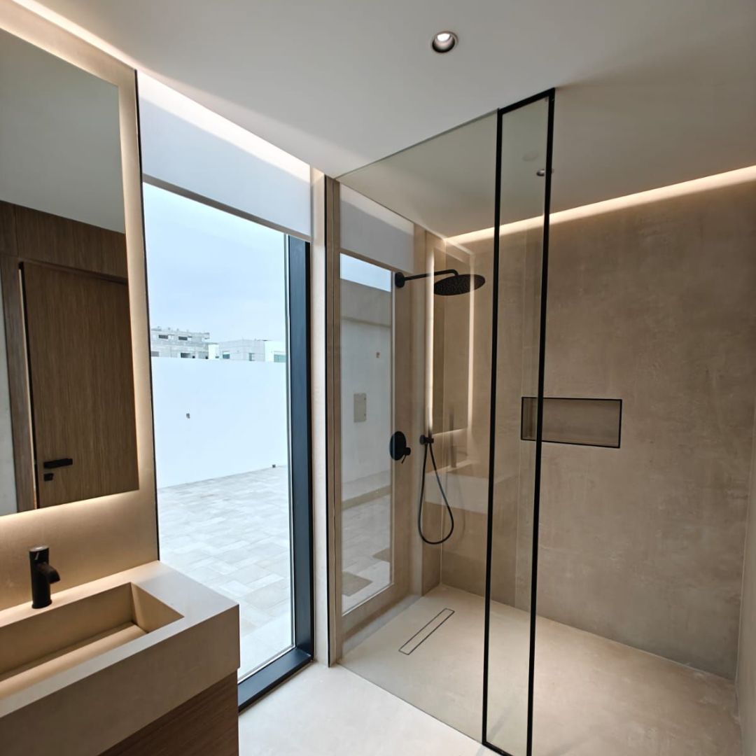 Luxury bathroom renovation Dubai with glass shower and marble finishes by Concept Art Decor