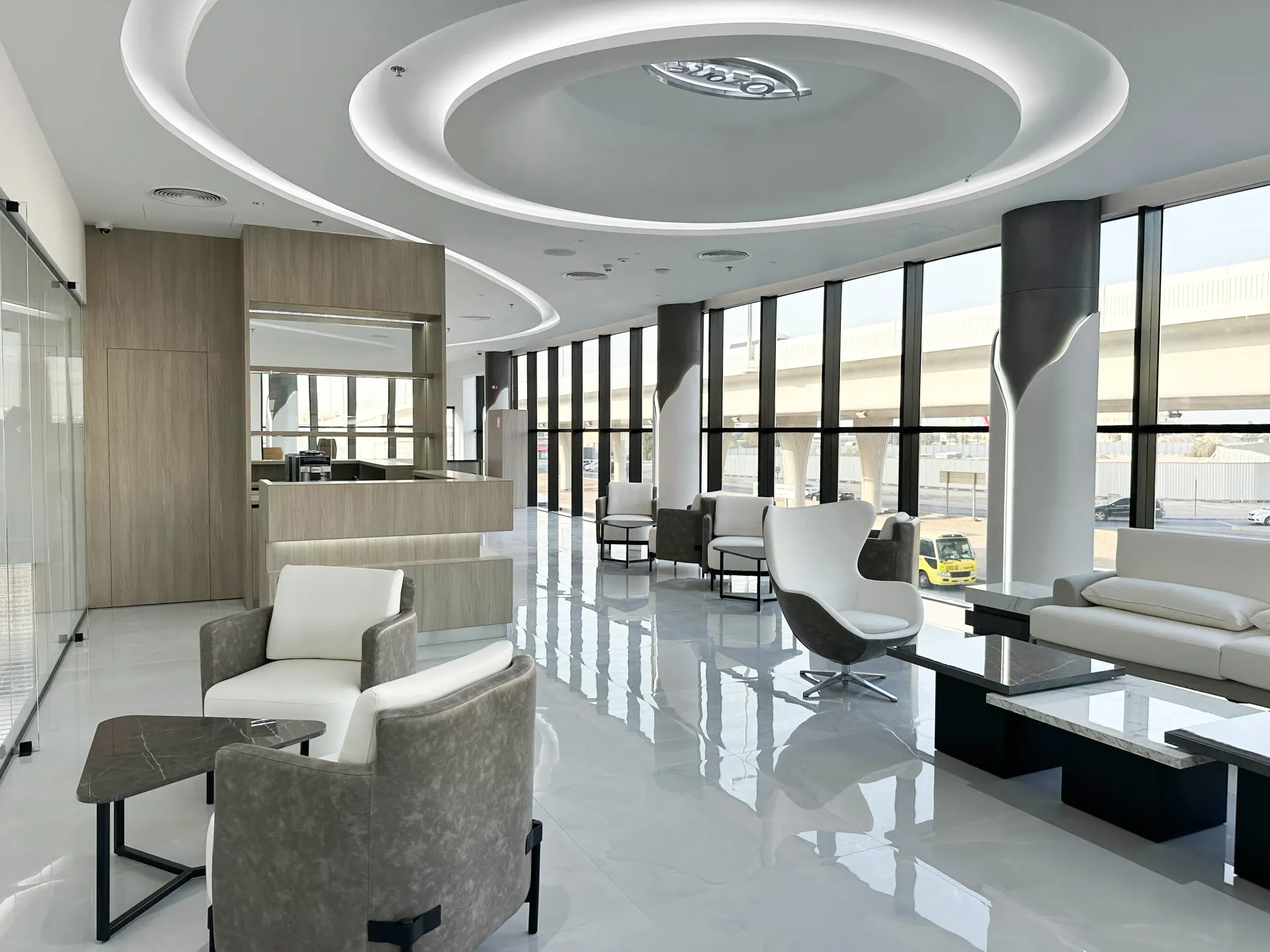 High-end showroom lounge interior in Dubai with premium joinery, seating, architectural ceiling by Concept Art Decor