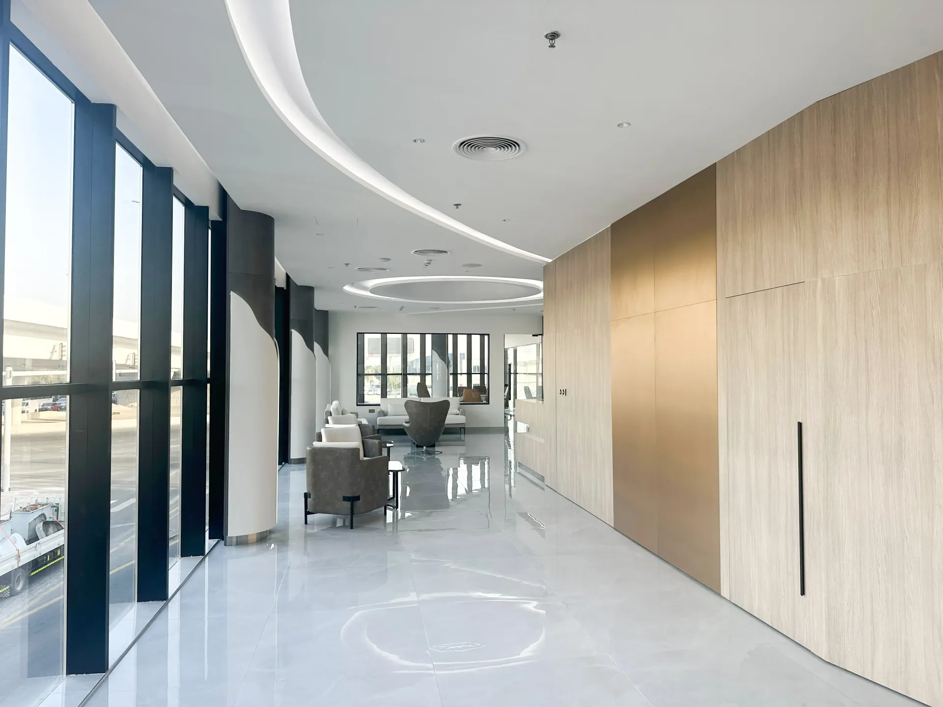 High-end showroom lounge interior in Dubai with premium seating, architectural ceiling features and glazing by Concept Art Decor