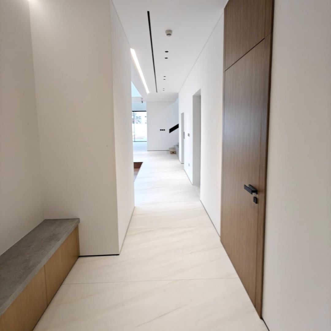 Open-plan villa corridor with recessed lighting and bespoke joinery Dubai by Concept Art Decor