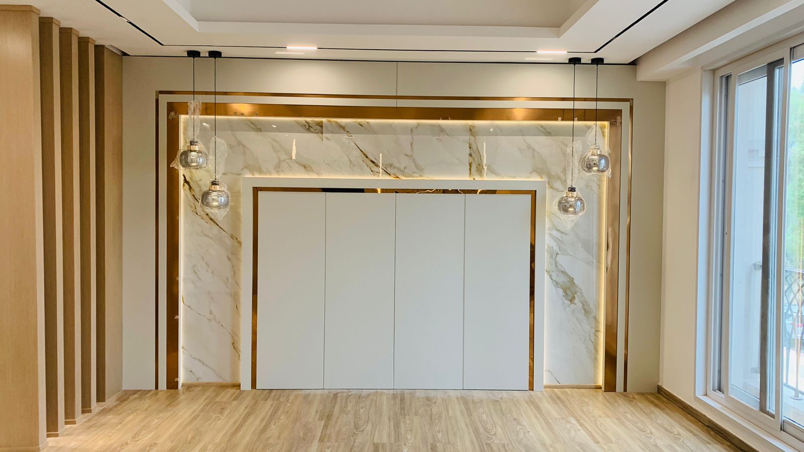 Palm Jumeirah luxury villa living room marble feature wall and gold detail by Concept Art Decor
