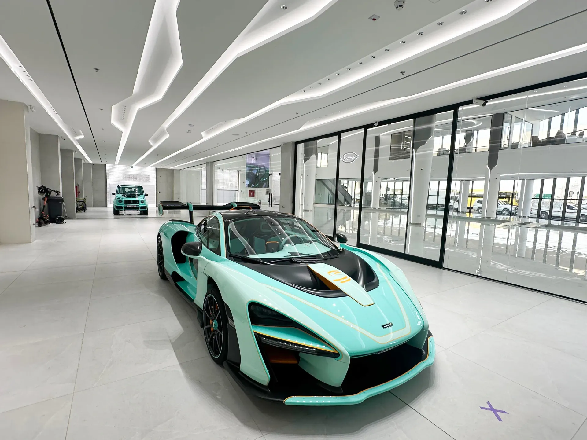 Luxury automotive showroom interior fit-out in Dubai featuring custom lighting and premium finishes by Concept Art Decor
