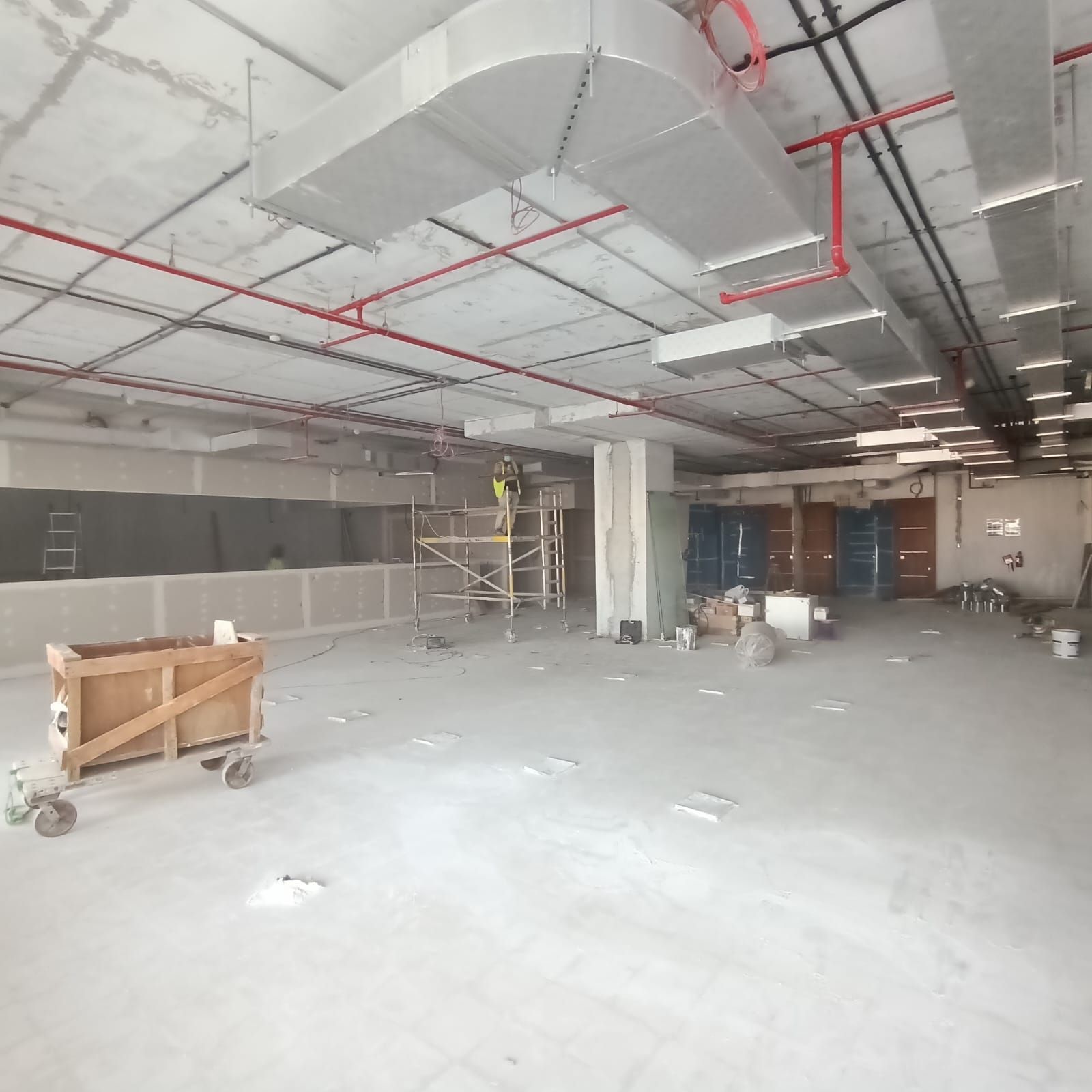 Commercial office construction phase Dubai exposed MEP ceiling installation