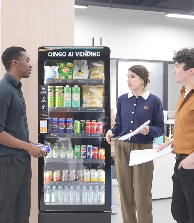 Person using a vending machine in a convenience center; several other machines are visible.