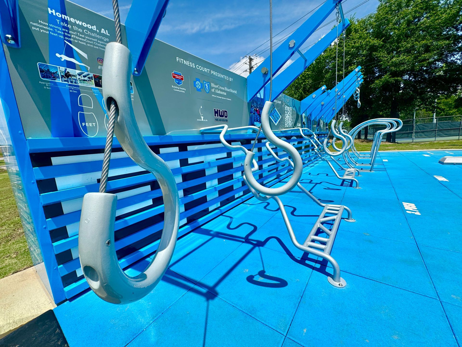 A row of hooks are hanging from a blue wall