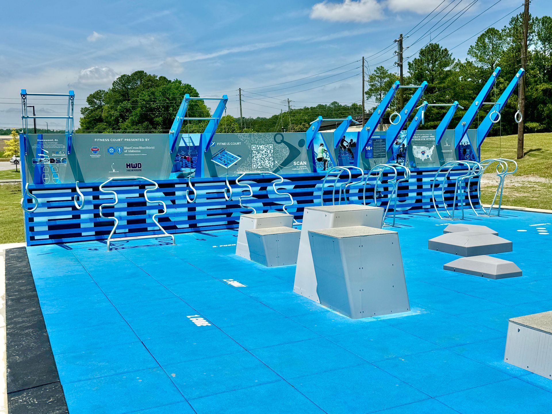 A blue and white playground with a lot of exercise equipment.
