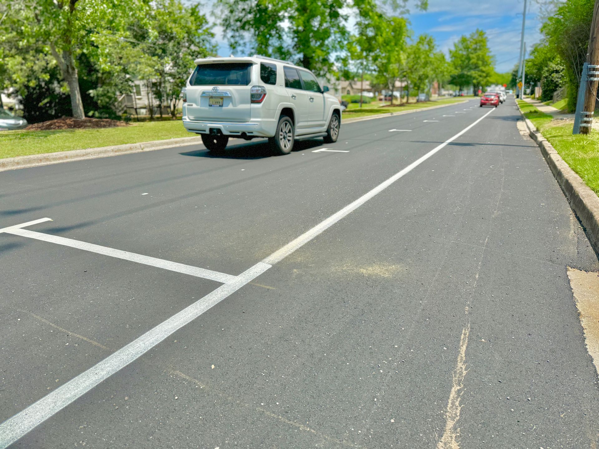 A white van is parked on the side of the road.