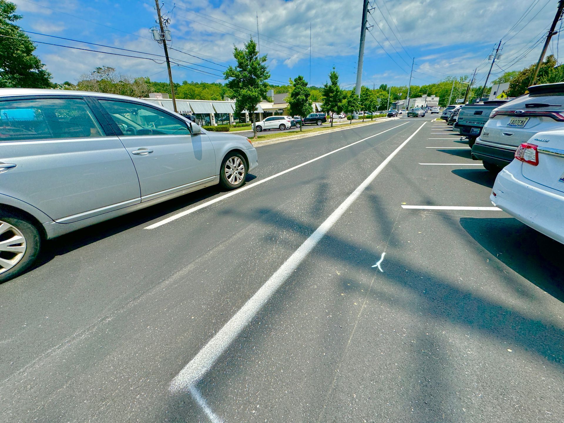 A row of cars are parked on the side of the road.