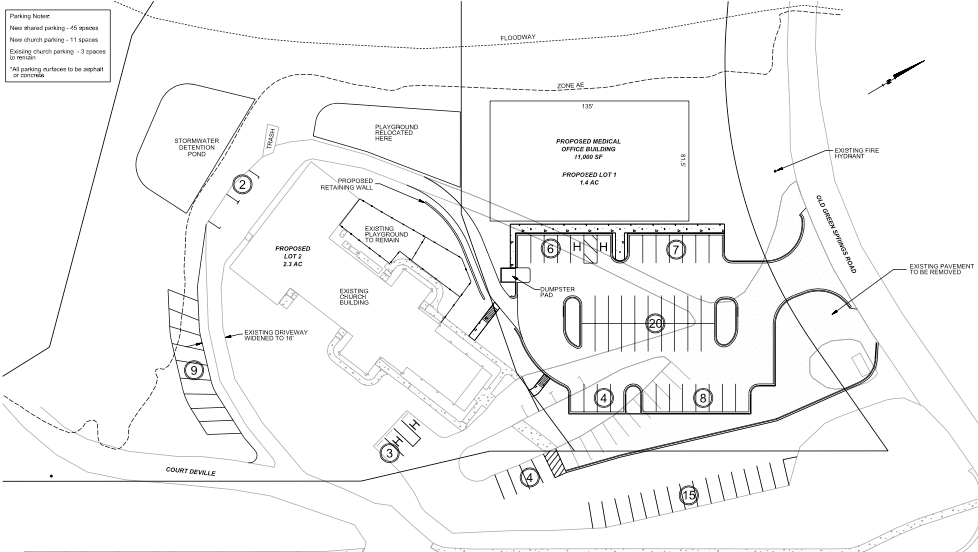 A black and white drawing of a parking lot with a building in the middle.