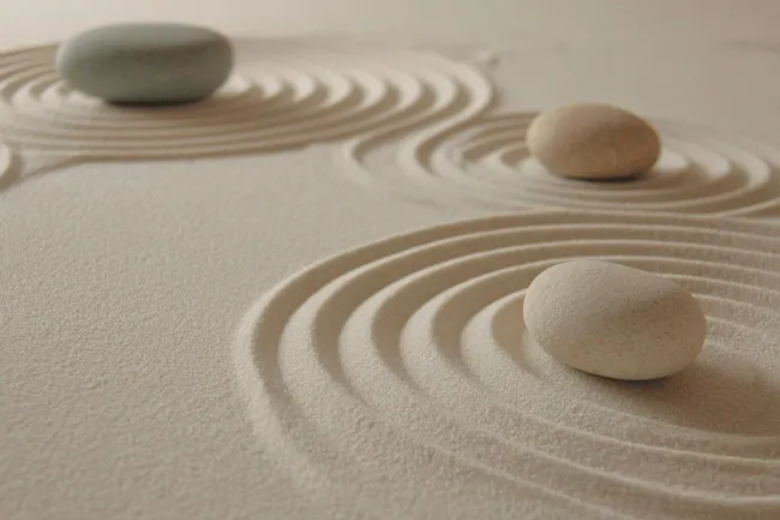 Two hands reaching toward each other over a soft, cream-colored symbol above rolling green hills