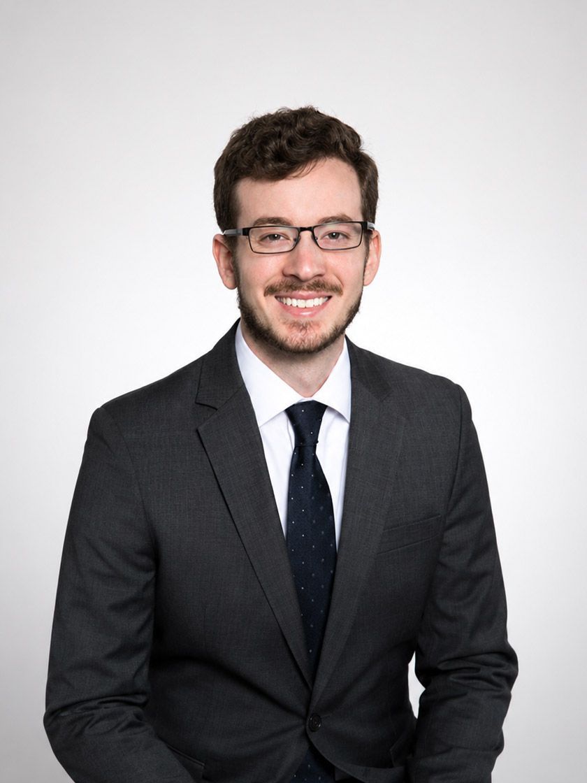 Dr. Matthew Bonn in a dark suit and tie against a plain light background
