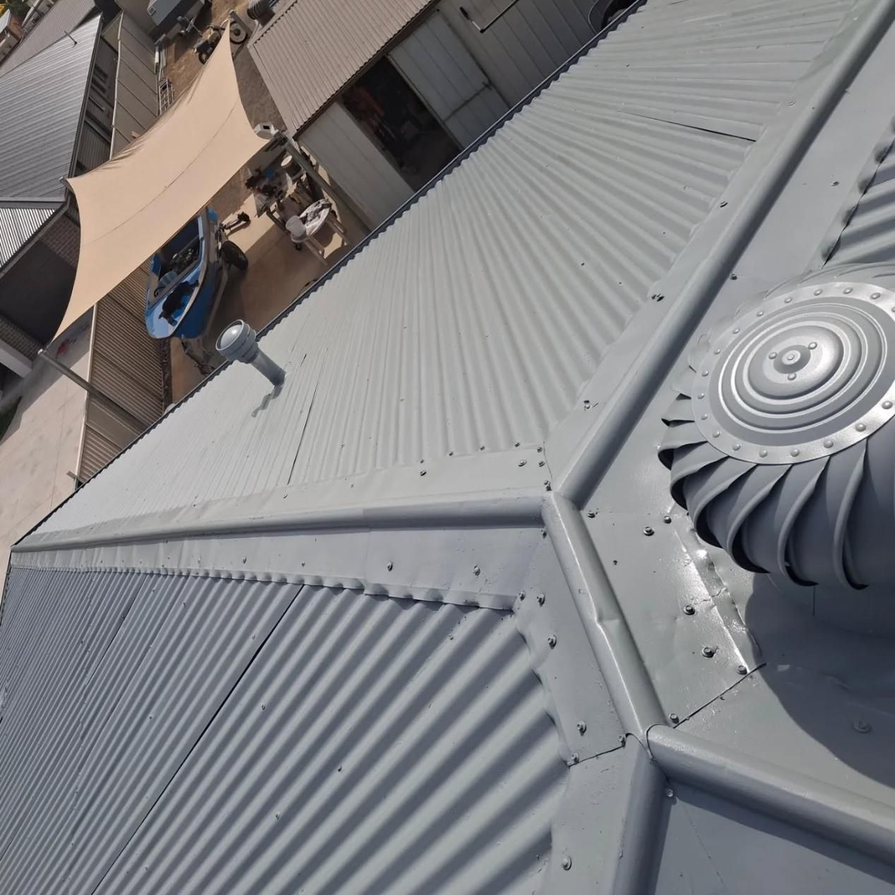 A Close Up Of A Tiled Roof With A Cloudy Sky In The Background — Roofworx Group In Bathurst, NSW