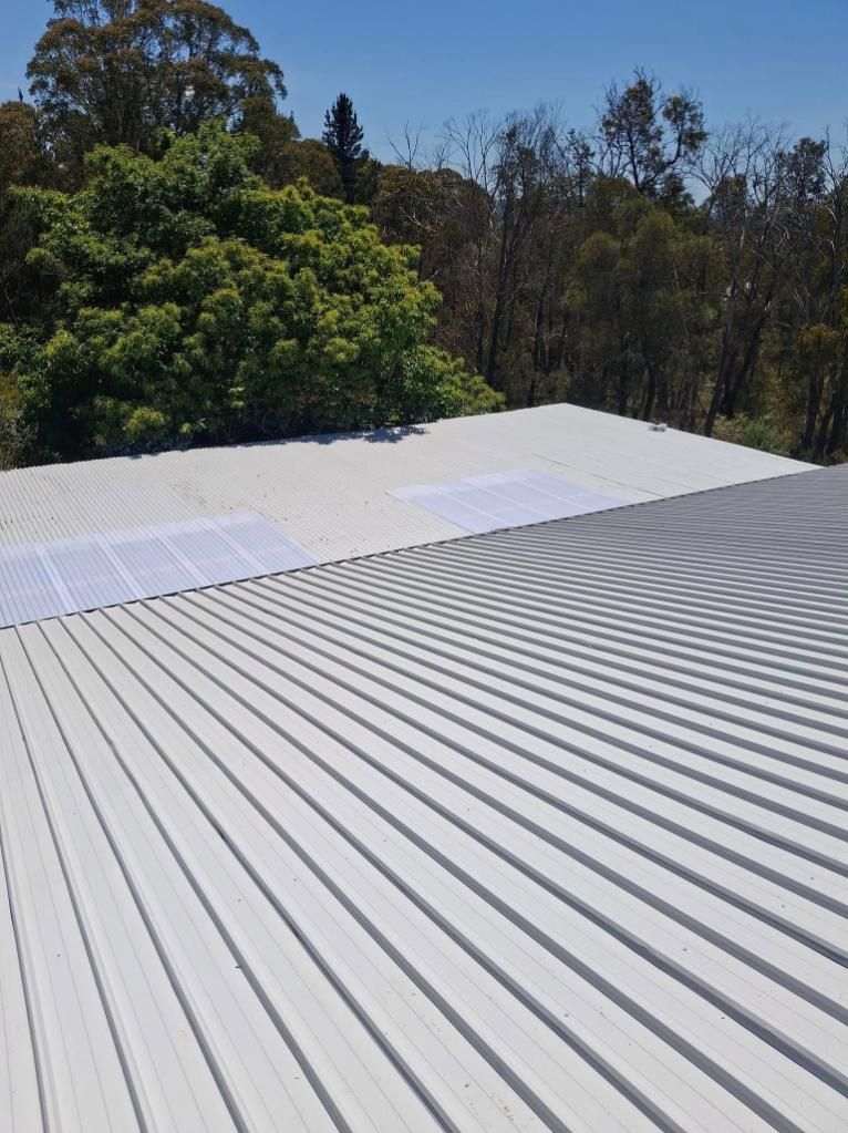 A White Metal Roof With Trees In The Background — Roofworx Group In Bathurst, NSW
