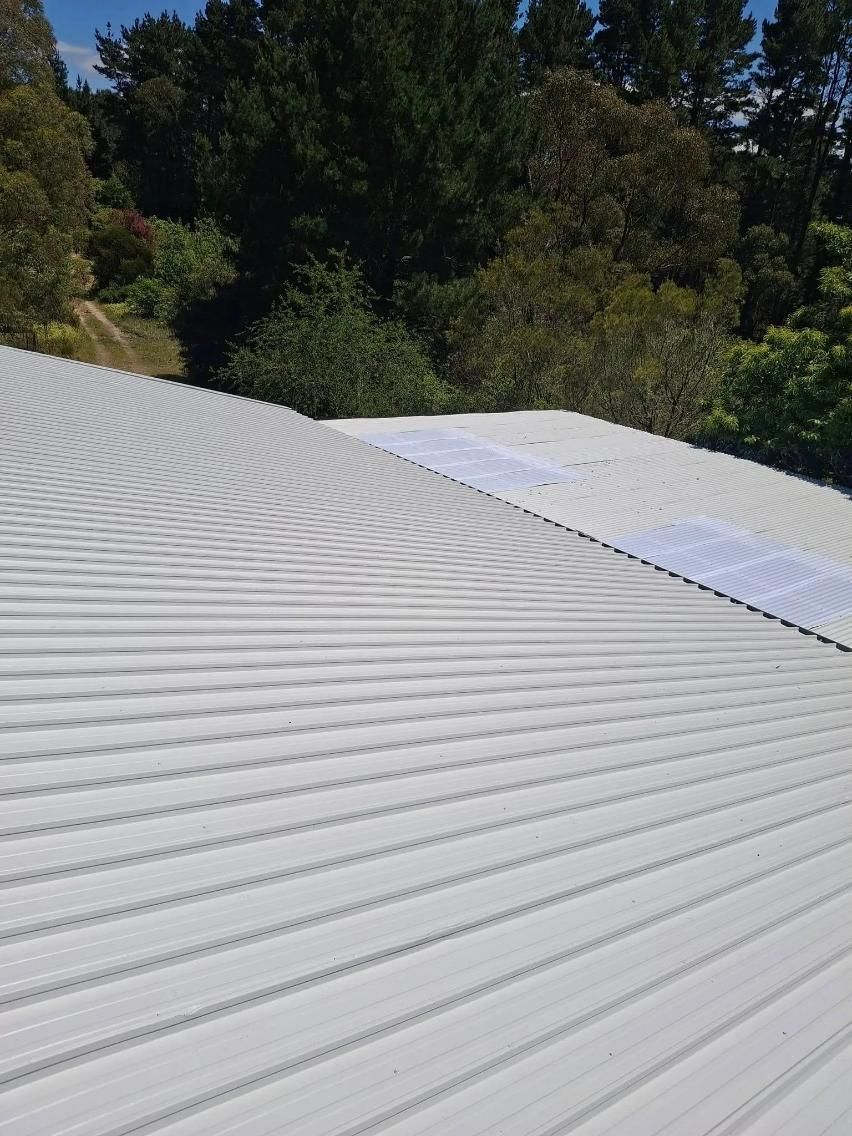 A Close Up Of A White Roof With Trees In The Background — Roofworx Group In Bathurst, NSW
