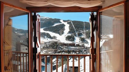 A balcony with a view of a ski slope
