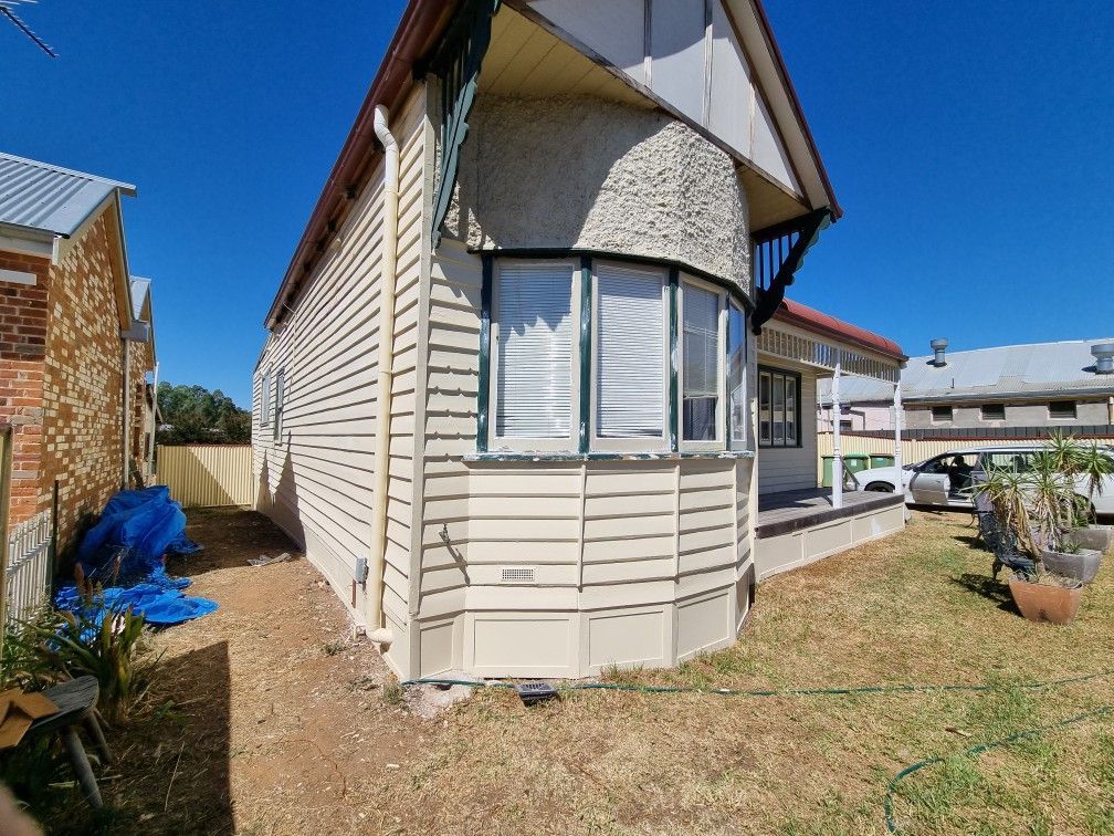 A house with a large window on the side of it — Recoat Painting In West Wodonga, VIC