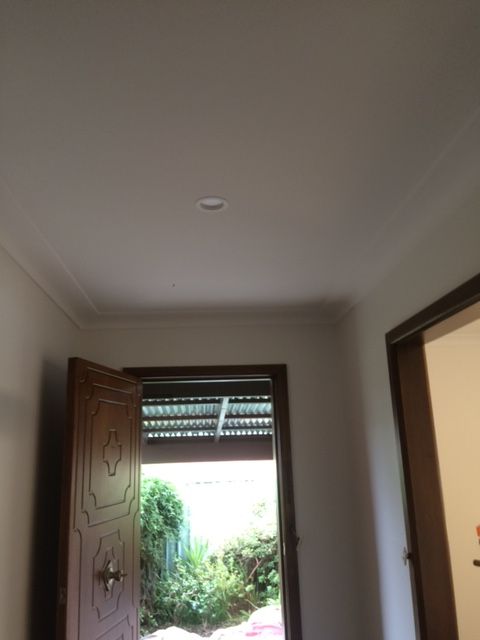 A hallway with an open door and a ceiling light — Recoat Painting In West Wodonga, VIC