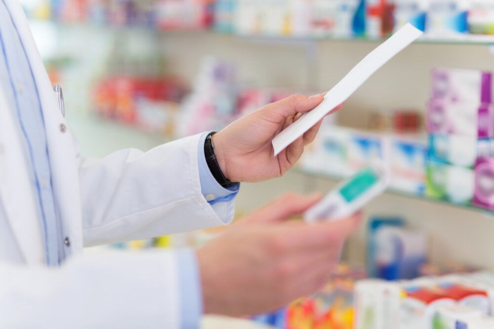 a person holding a piece of paper and up close— Bluewater Pharmacy in Yabulu, QLD