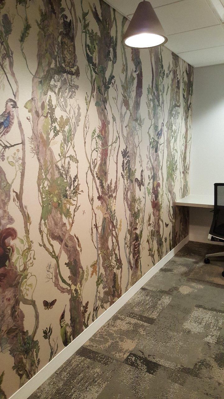 A room with a painting on the wall and a lamp on the ceiling.