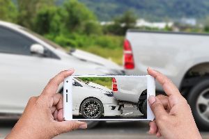 Person taking picture of car accident — Waipahu, HI — Westside Fender/Body & Refinishing Person taking picture of car accident — Waipahu, HI — Westside Fender/Body & Refinishing