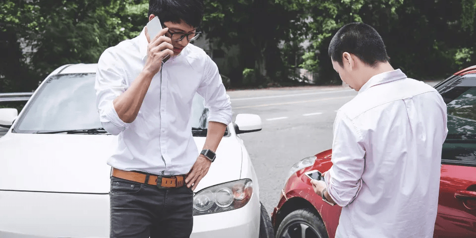 Two men discussing car accident — Waipahu, HI — Westside Fender/Body & Refinishing