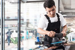 Mechanic polishing black car — Waipahu, HI — Westside Fender/Body & Refinishing Mechanic polishing black car — Waipahu, HI — Westside Fender/Body & Refinishing