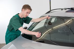 Mechanic inspecting windshield — Waipahu, HI — Westside Fender/Body & Refinishing Mechanic inspecting windshield — Waipahu, HI — Westside Fender/Body & Refinishing
