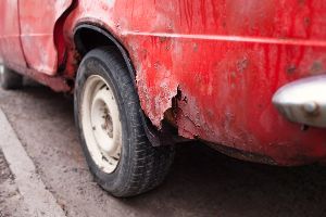 Dirty and broken red car — Waipahu, HI — Westside Fender/Body & Refinishing Dirty and broken red car — Waipahu, HI — Westside Fender/Body & Refinishing