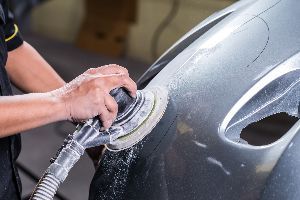 Mechanic cleaning car — Waipahu, HI — Westside Fender/Body & Refinishing Mechanic cleaning car — Waipahu, HI — Westside Fender/Body & Refinishing