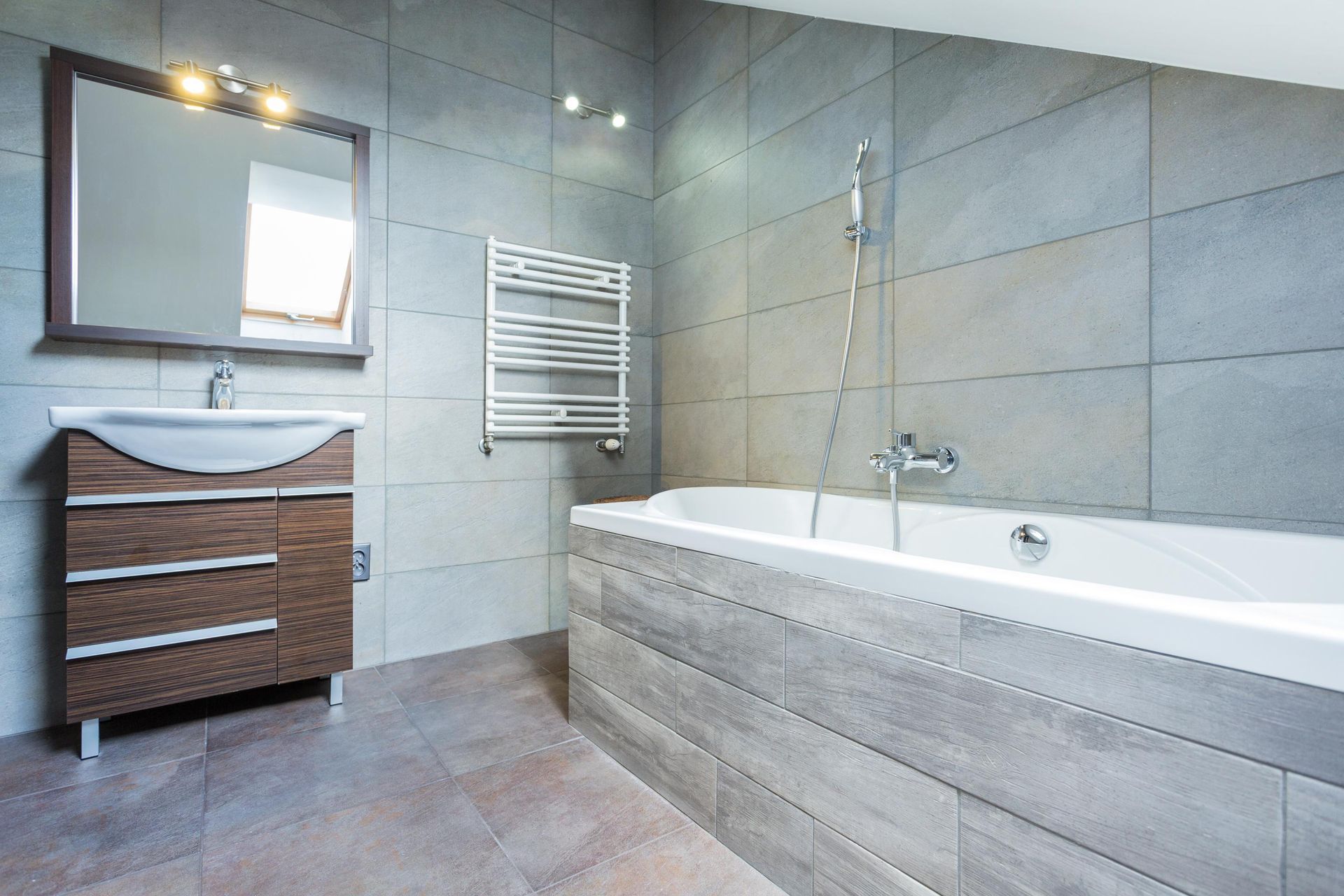 a bathroom with a bathtub a sink and a mirror