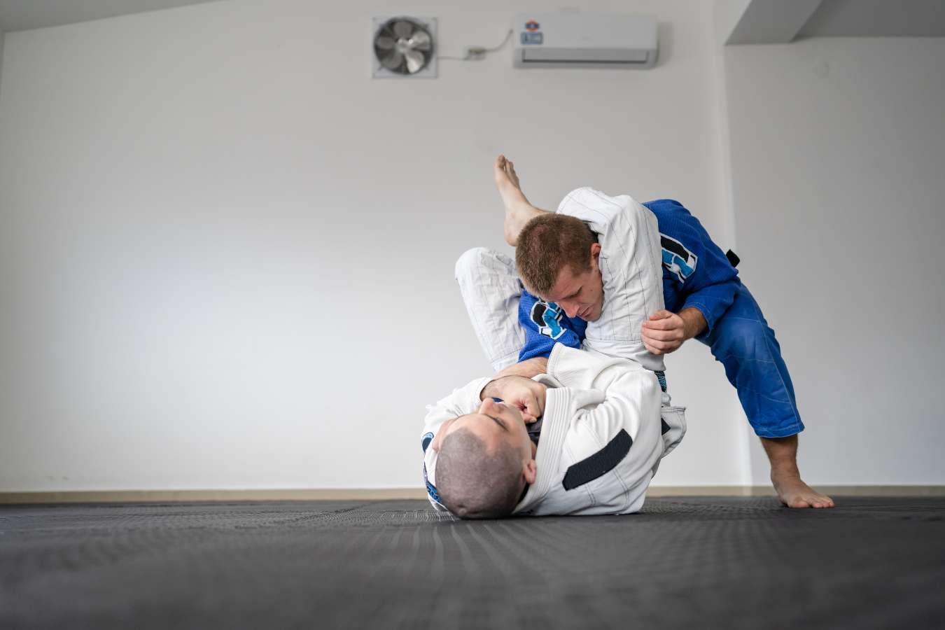 Adults practicing controlled Jiu-Jitsu sparring at Almighty Jiu-Jitsu in Huntington Beach, CA.