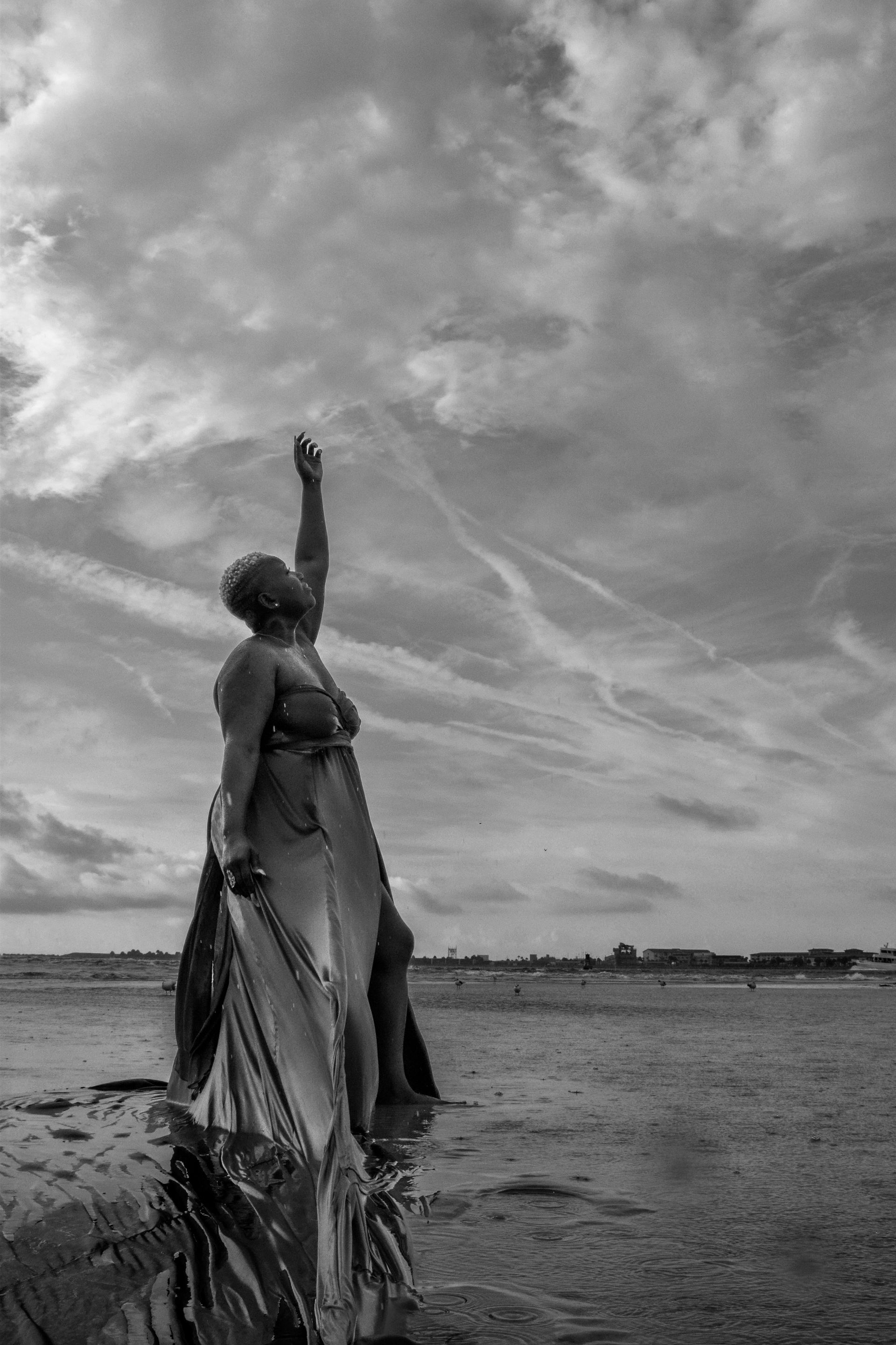 Portrait of SoFree beneath a dramatic sky representing faith, hope, and emotional healing.