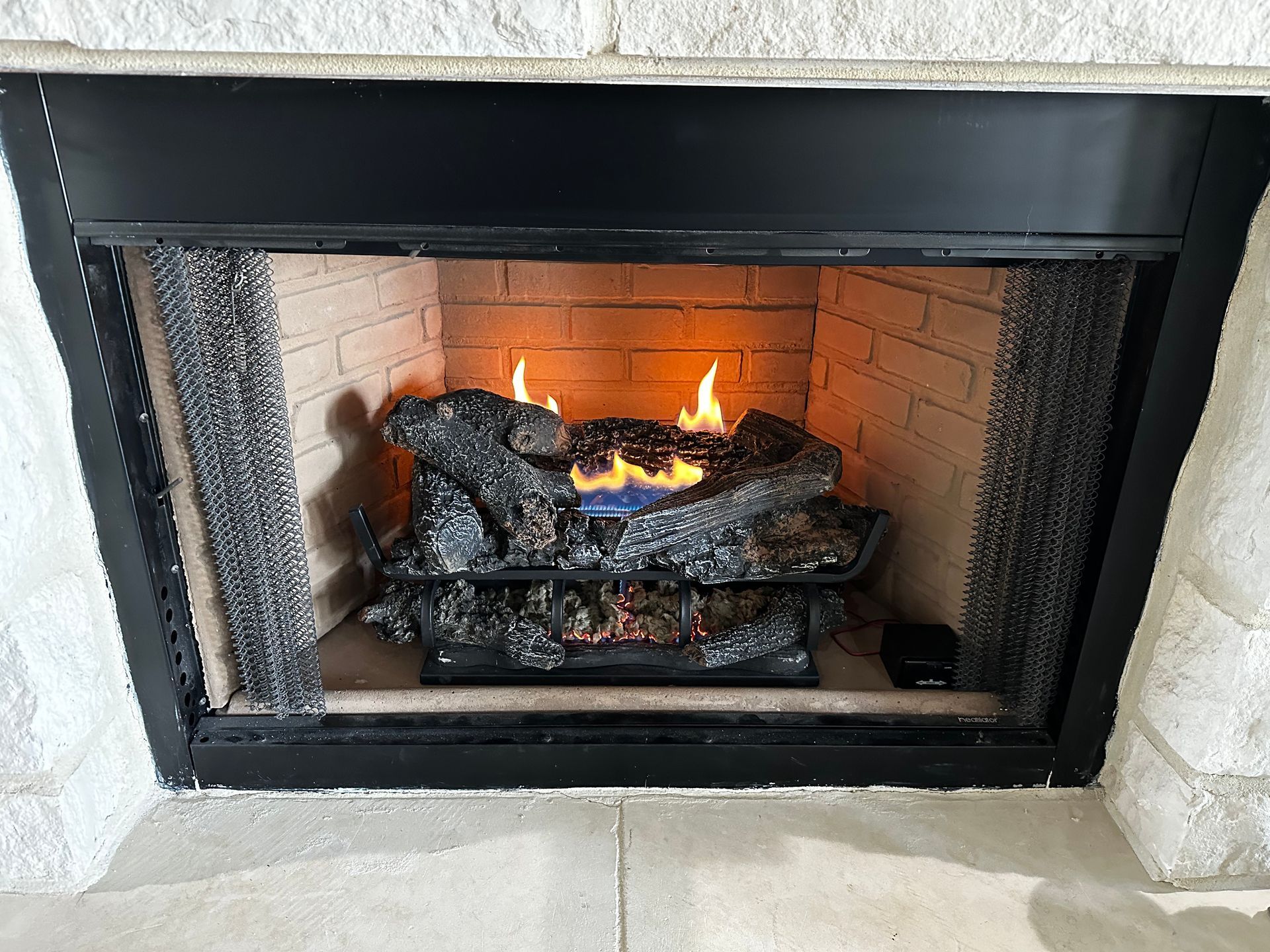 A fireplace with a bunch of logs in it