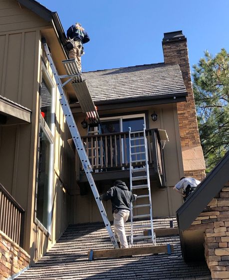 Installation of seamless aluminum rain gutters.