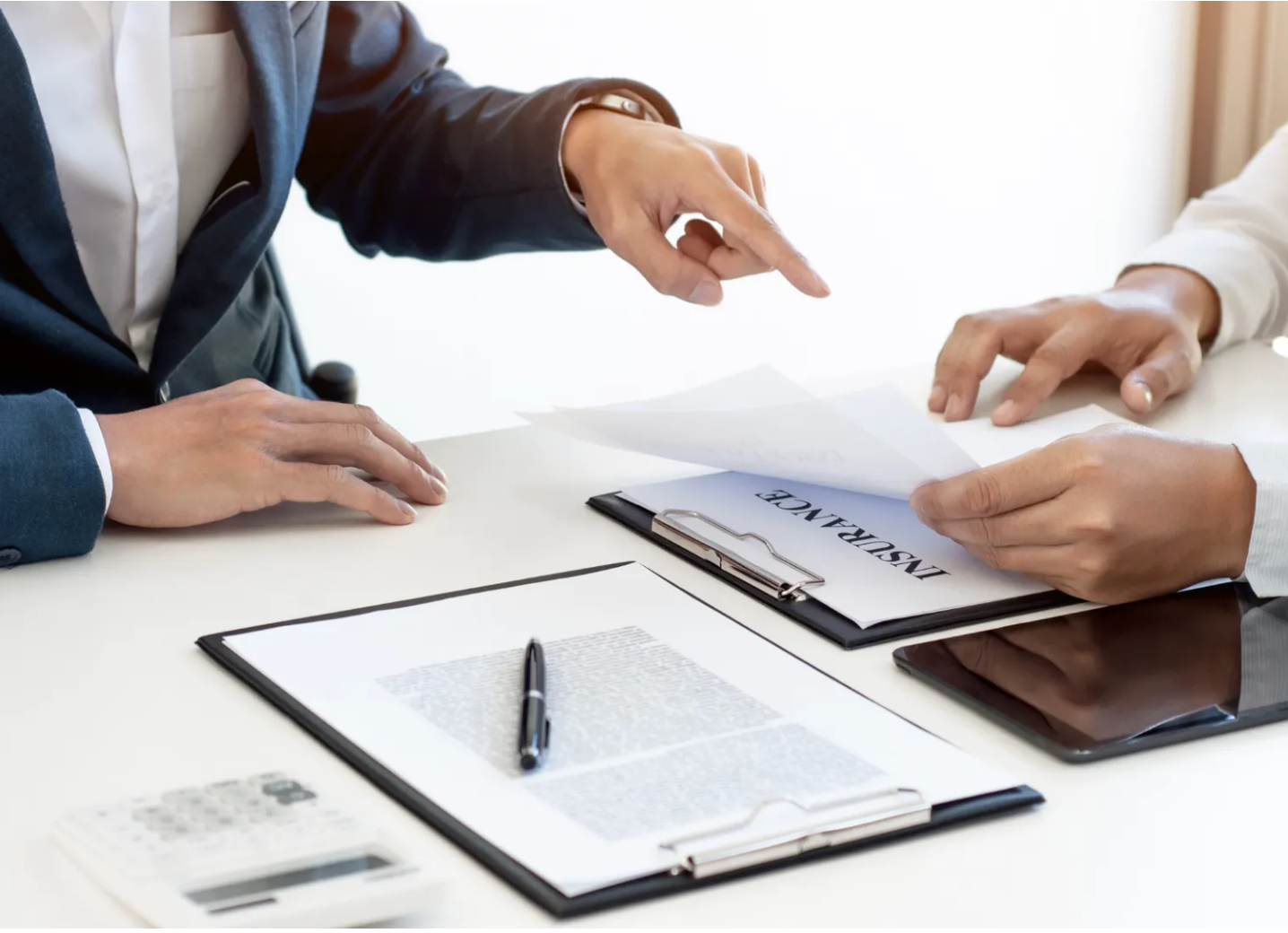 Two people are sitting at a table looking at a piece of paper.