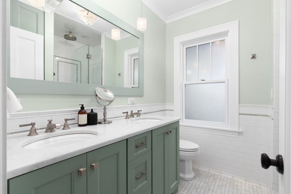 Bathroom with green vanity, marble countertop, large mirror, and white tile. — Dimond J Carpentry in Maroochydore, QLD