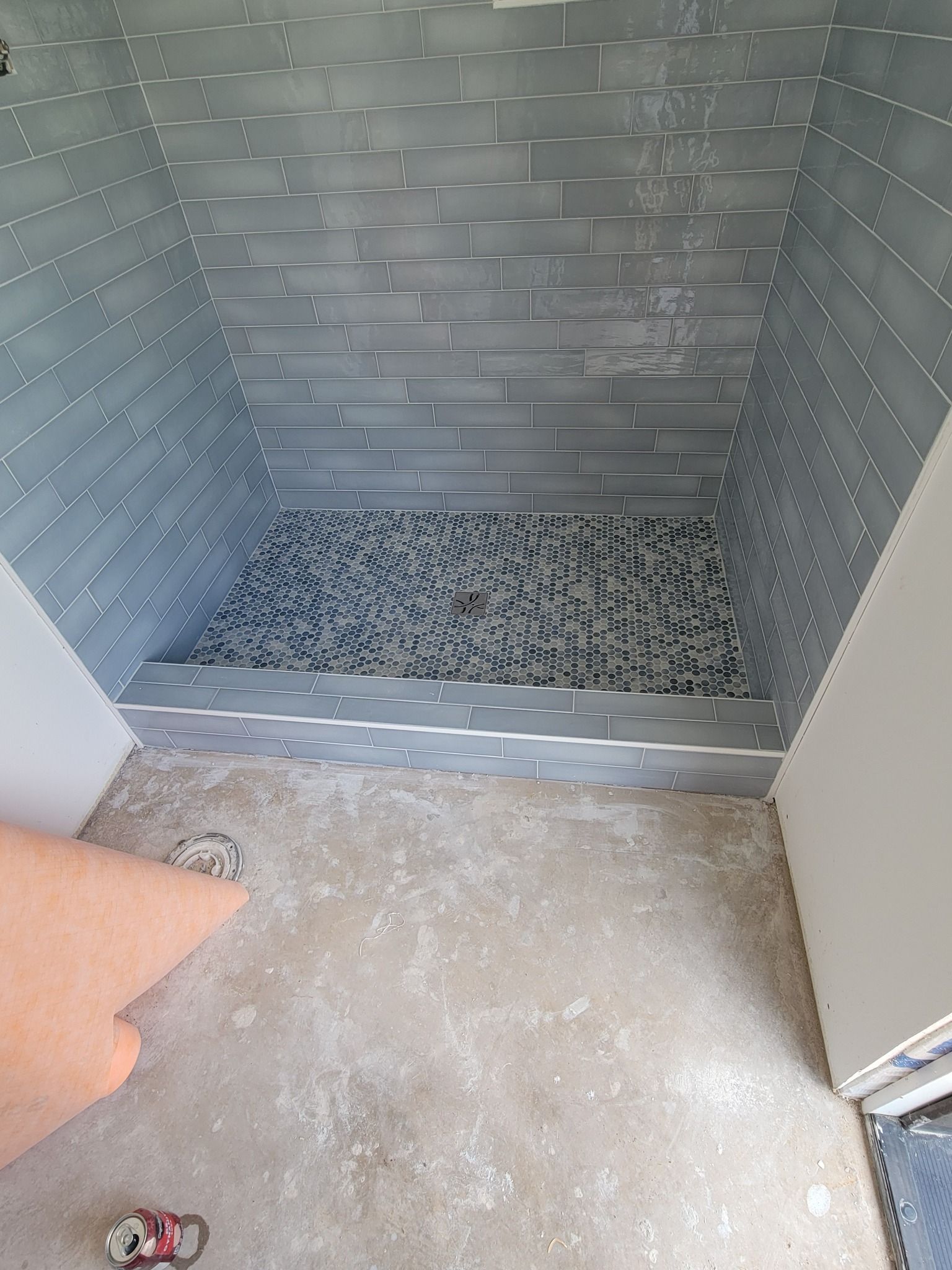 Empty metal bin with a speckled floor and open doors, viewed from above