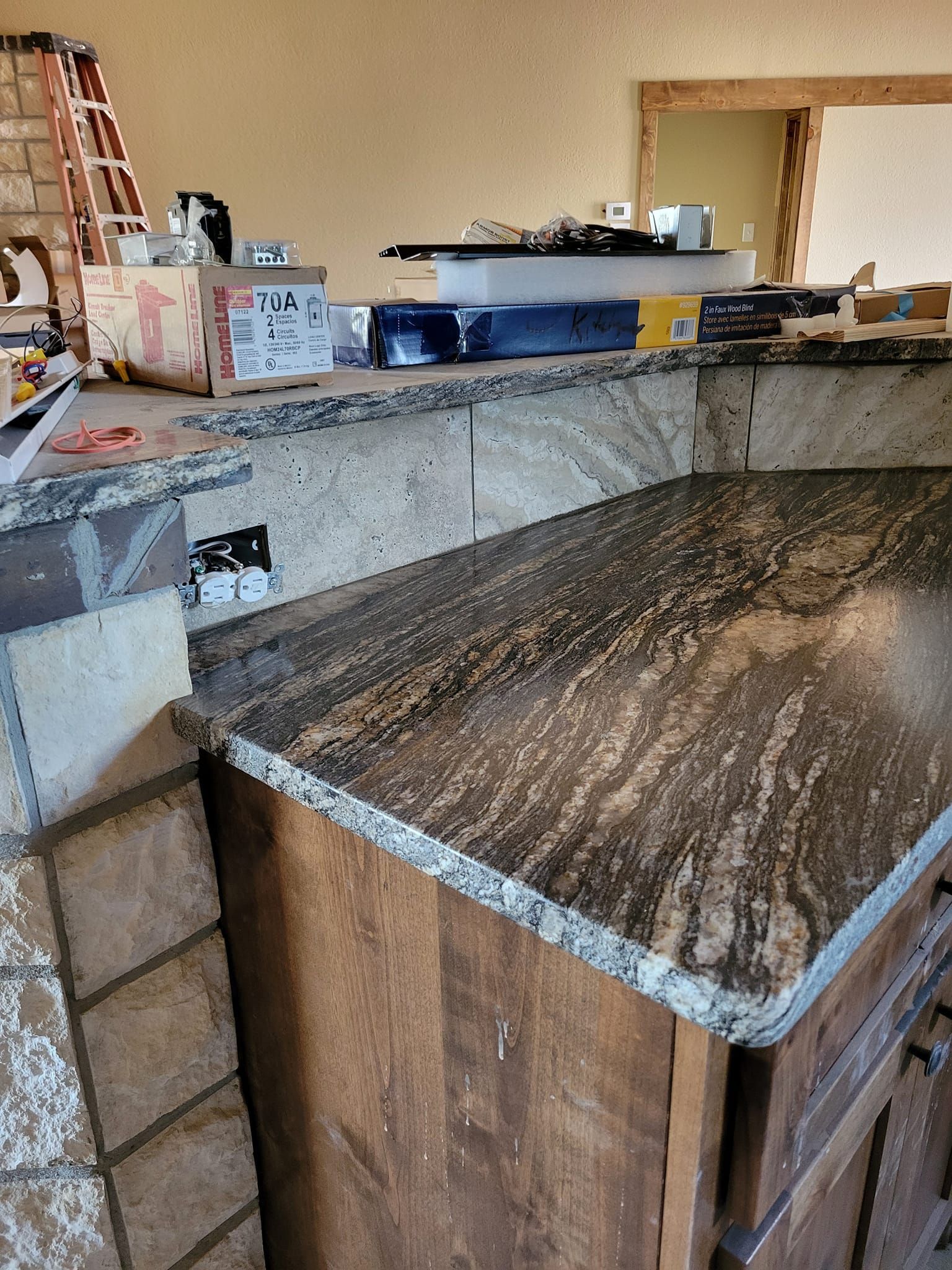 Stone countertop with a wooden cabinet in a kitchen or bar area.