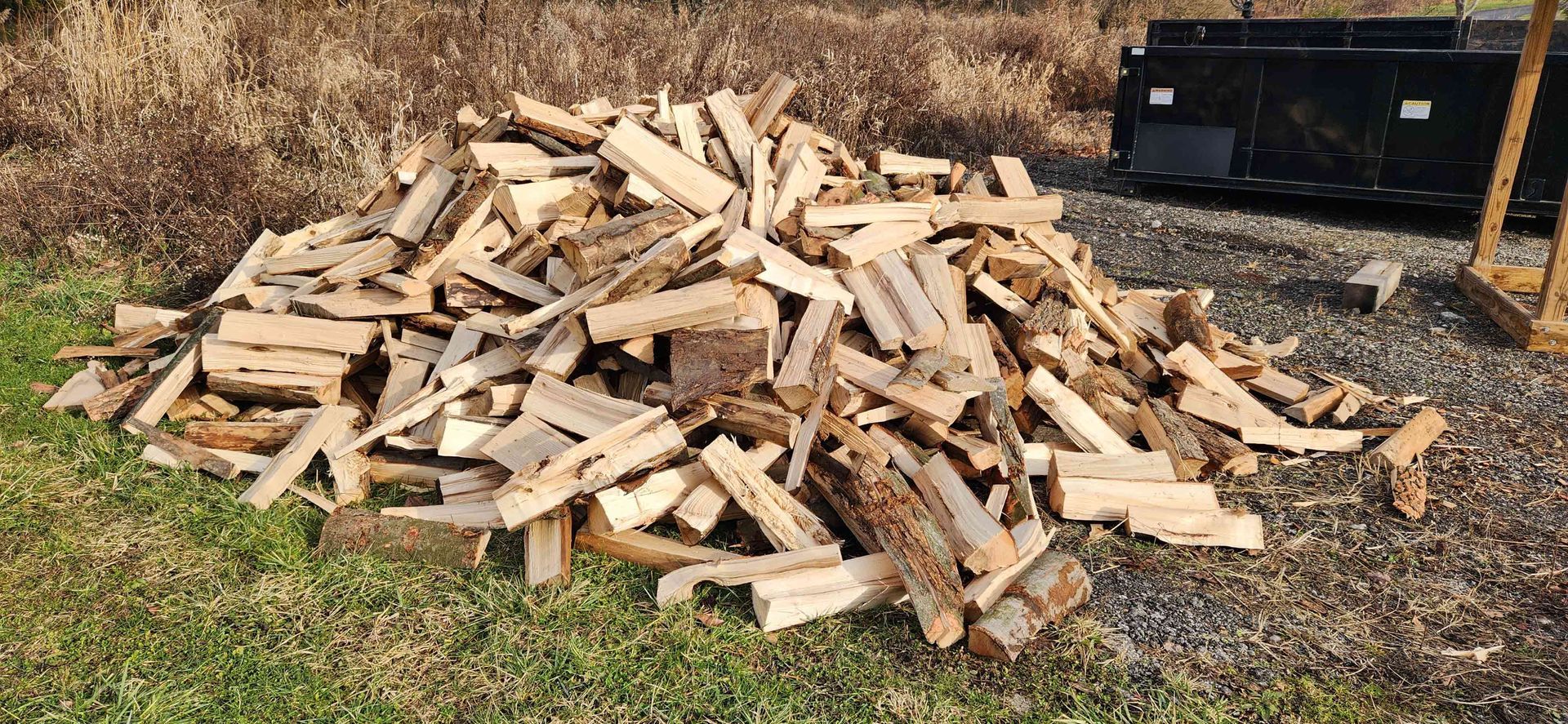Pile of Wood is Sitting in the Grass — Masury, OH — Hackett's Tree Service