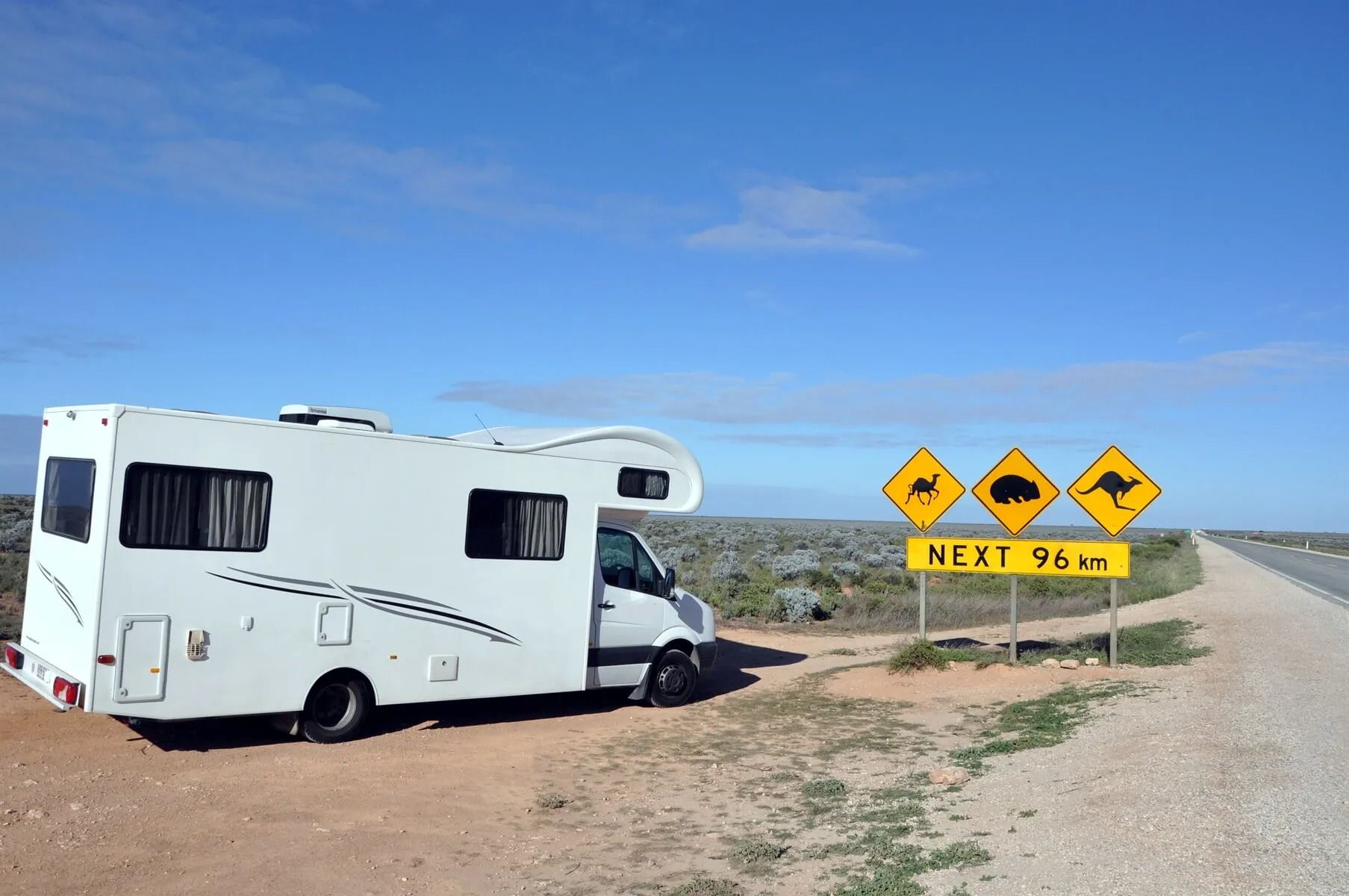 An RV is parked next to yellow signs — Mechanical World In Wagga Wagga, NSW
